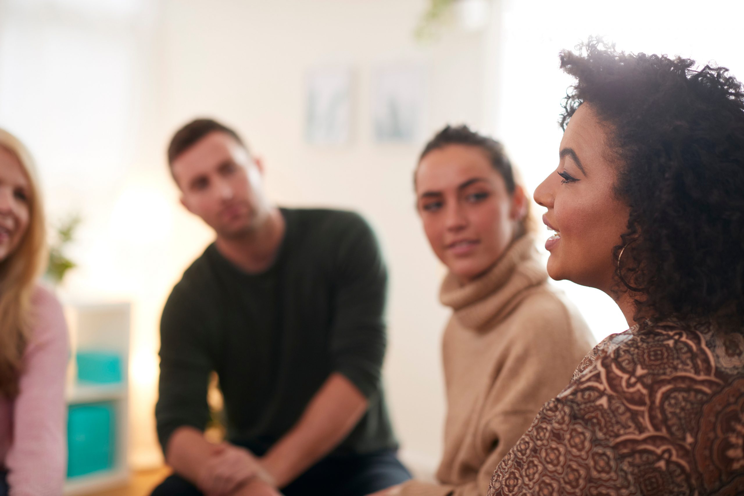 Woman Speaking At Support Group Meeting For Mental Health Or Dep