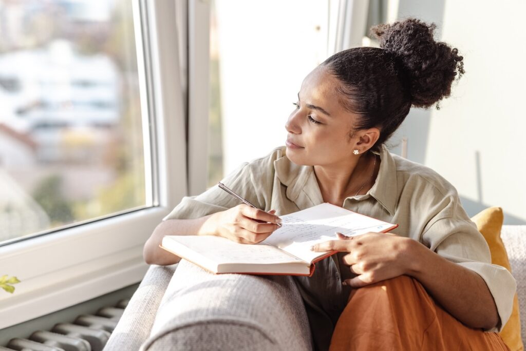 Young woman journaling at home after a counselling session