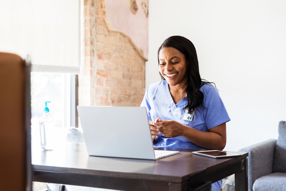 Happy doctor attending an online therapy session