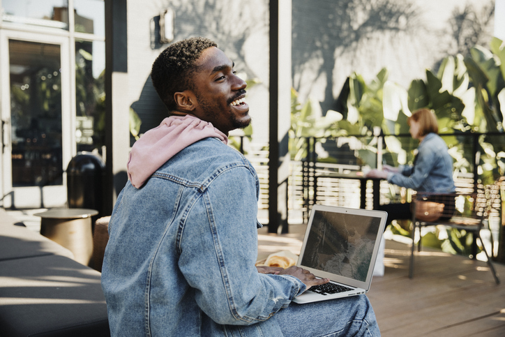 Man using a laptop in a cafe