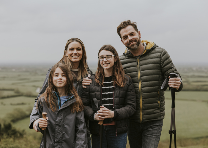 Happy family hiking on mountain, outdoor activity