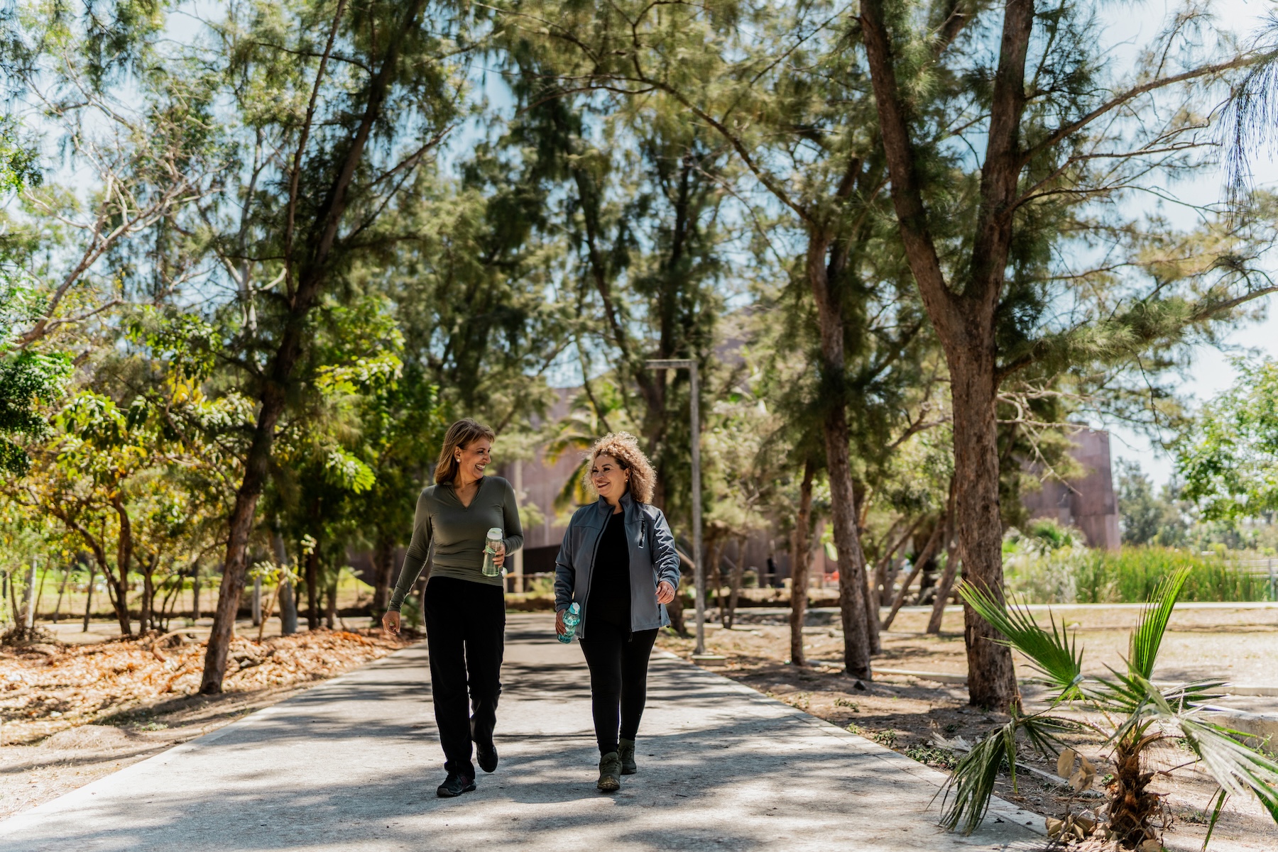 Senior women talking and walking thorugh the public park